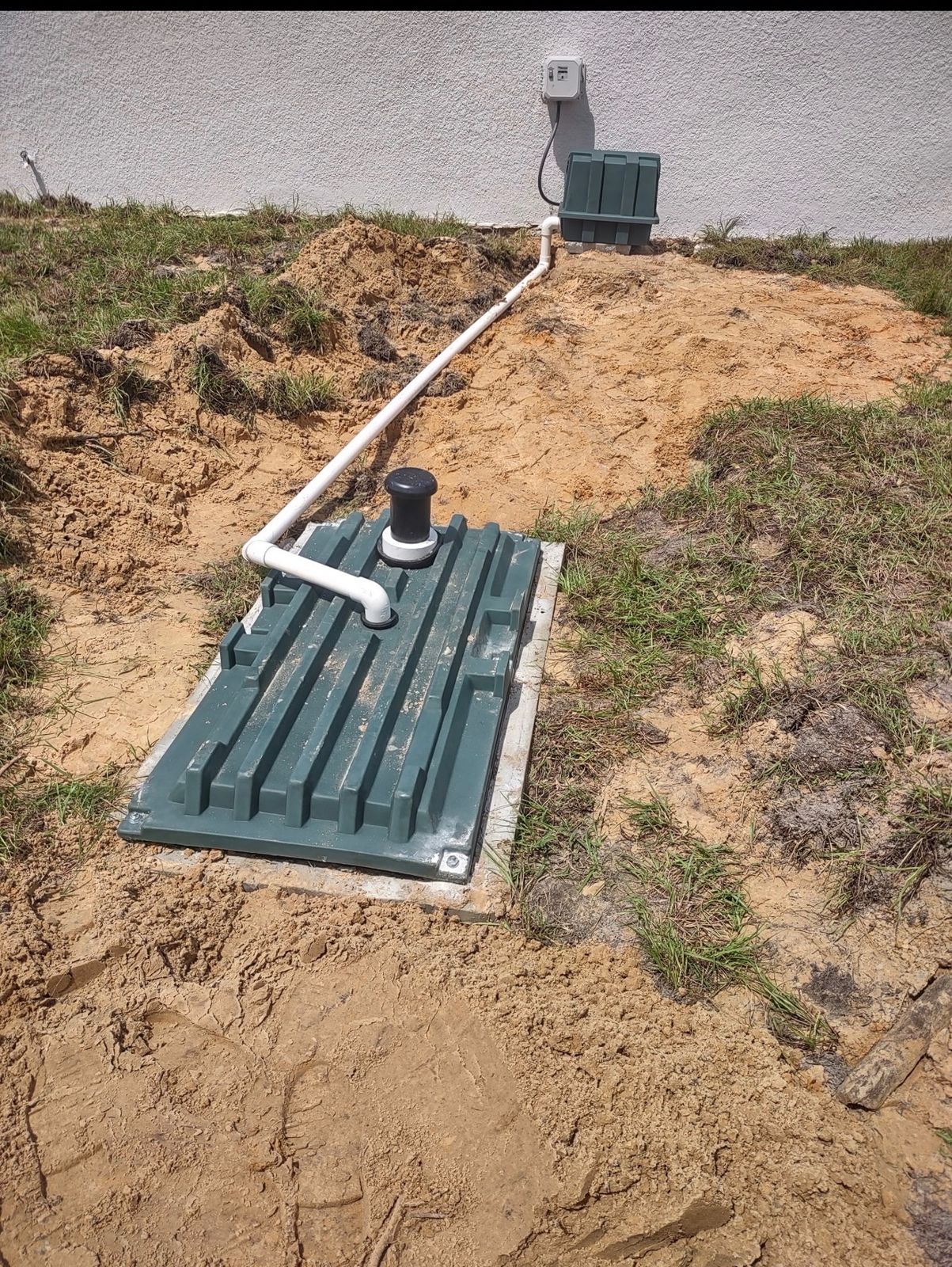 Septic tank access lid installed level with the yard after a Bonded Septic service call